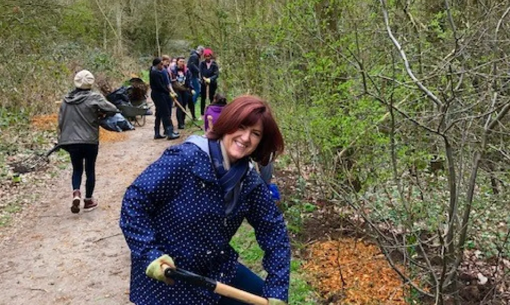 a woman holding a hay fork