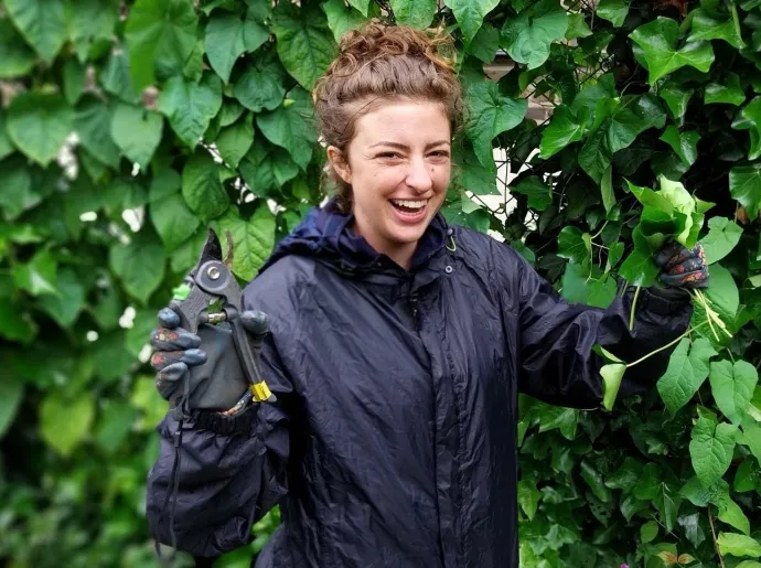 a woman cutting leaves