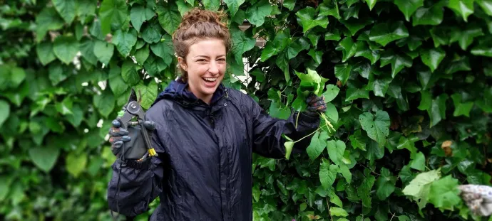 a woman cutting leaves