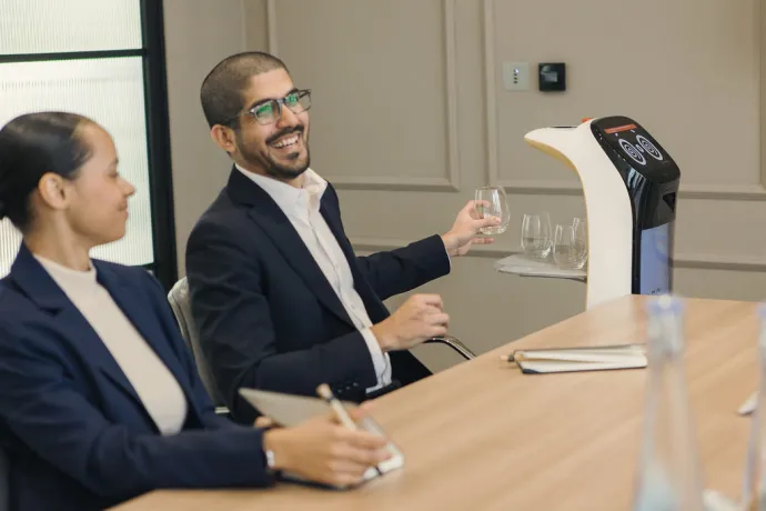 men smiling and holding a glass of water